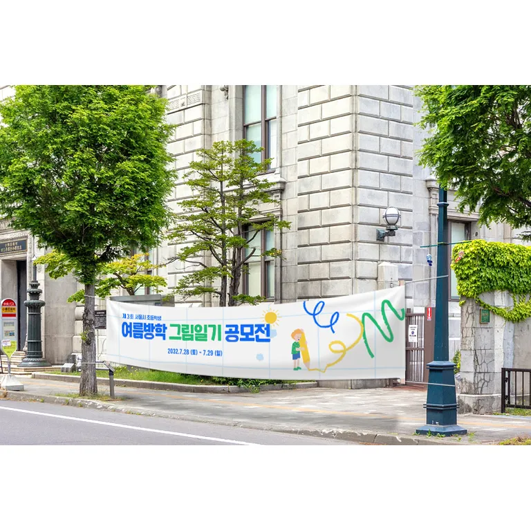 거리 건물 앞에 가로로 설치된 인쇄 현수막의 실제 설치 사진